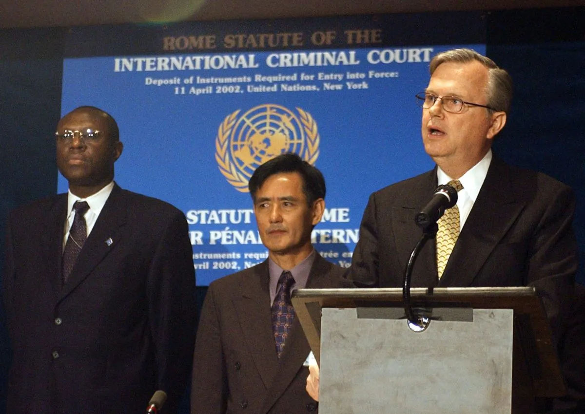 United Nations Under Secretary General Hans Corell (R) speaks at ceremony marking the ratification of the Rome statue of the International Criminal Court (ICC) as Democratic Republic of Congo Ambassador to the UN Atoki Ileka (L) and Cambodia Ambassador to the UN Sithong Neav (C) listen after presenting their country's instrument of ratification, 11 April 2002, at UN headquarters in New York. STAN HONDA/AFP/Getty Images
