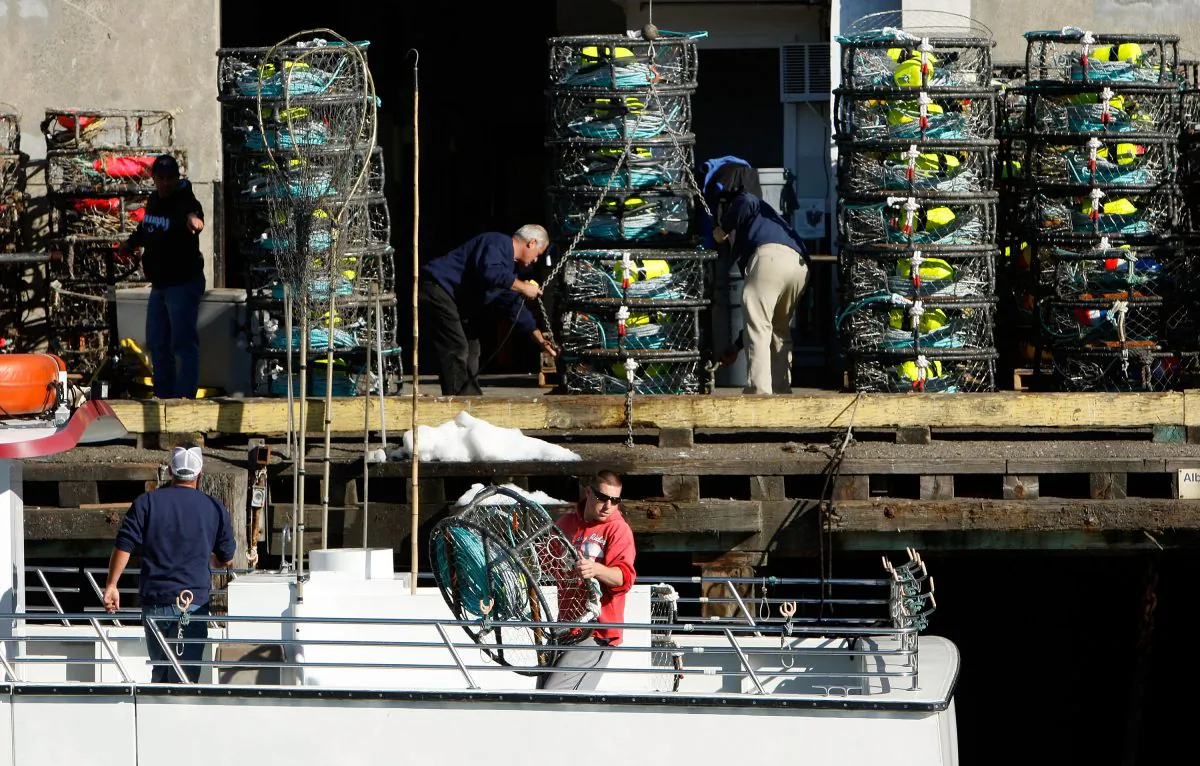 Crew members aboard the fishing boat "Outer Limits" load crab pots onto their boat at Pier 45 in San Francisco, Calif., on Nov. 30, 2007. (Justin Sullivan/Getty Images)