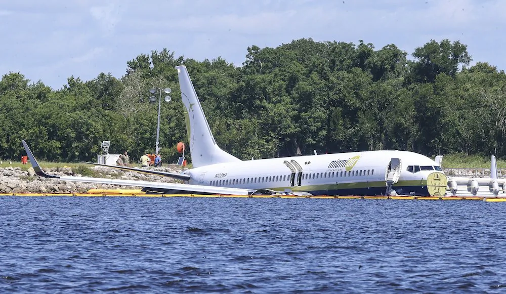 A charter plane carrying 143 people and traveling from Cuba to north Florida sits in a river at the end of a runway in Jacksonville, Fla., on May 4, 2019. (Gary McCullough/AP Photo)