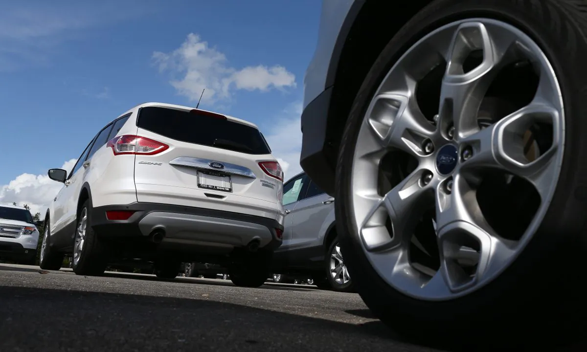 A wheel and a white SUV. (Joe Raedle/Getty Images)