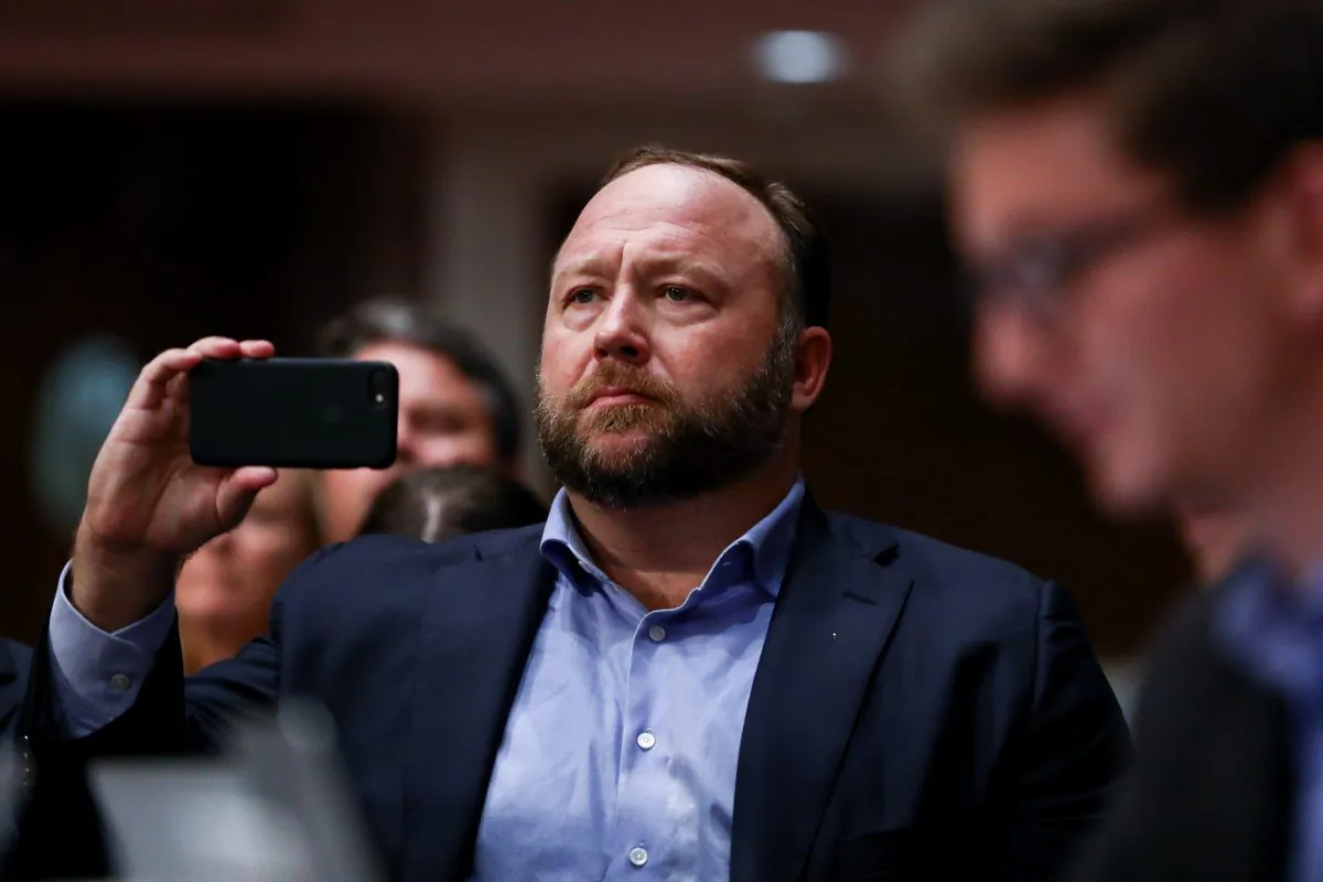 InfoWars founder Alex Jones takes photos at a hearing to examine foreign influence operations' use of social media platforms before the Intelligence Committee at the Capitol in Washington on Sept. 5, 2018. (Samira Bouaou/The Epoch Times)
