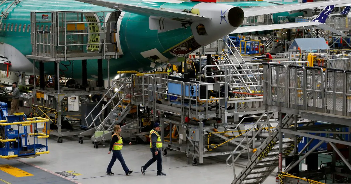 Employees walk by the end of a 737 Max aircraft at the Boeing factory in Renton, Washington, U.S., March 27, 2019. (Lindsey Wasson/Reuters)