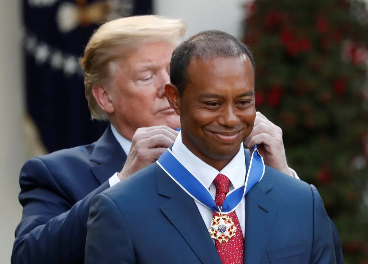 President Donald Trump hangs the Presidential Medal of Freedom around Golf Champion Tiger Woods's neck at the White House Rose Garden in Washington, on May 6, 2019. (Kevin Lamarque/Reuters)
