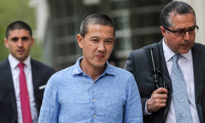 Ex-Goldman Sachs banker Roger Ng and his lawyer Marc Agnifilo leave the federal court in New York on May 6, 2019. (Jeenah Moon/Reuters)