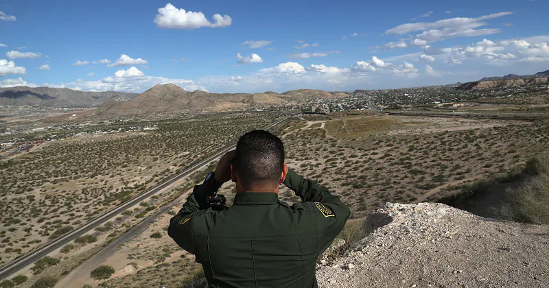 A Border Patrol official looks out into the distant areas around Sunland Park, New Mexico, on Oct. 4, 2016. (John Moore/Getty Images)