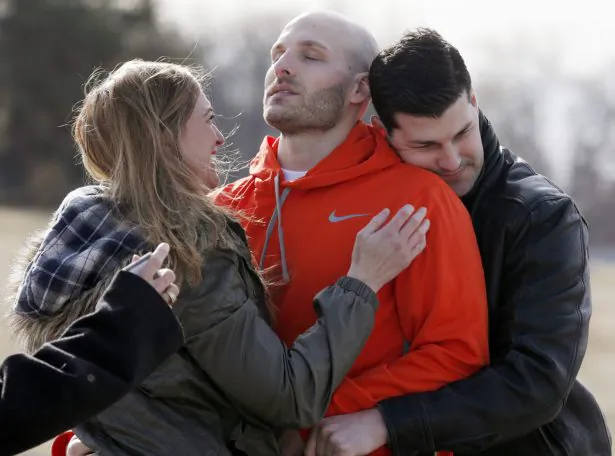 Michael Behenna (C), is embraced by his brother Brett and girlfriend Shannon Wahl following his release from prison in Leavenworth, Kan., on March 14, 2014. (Sarah Phipps/The Oklahoman via AP)
