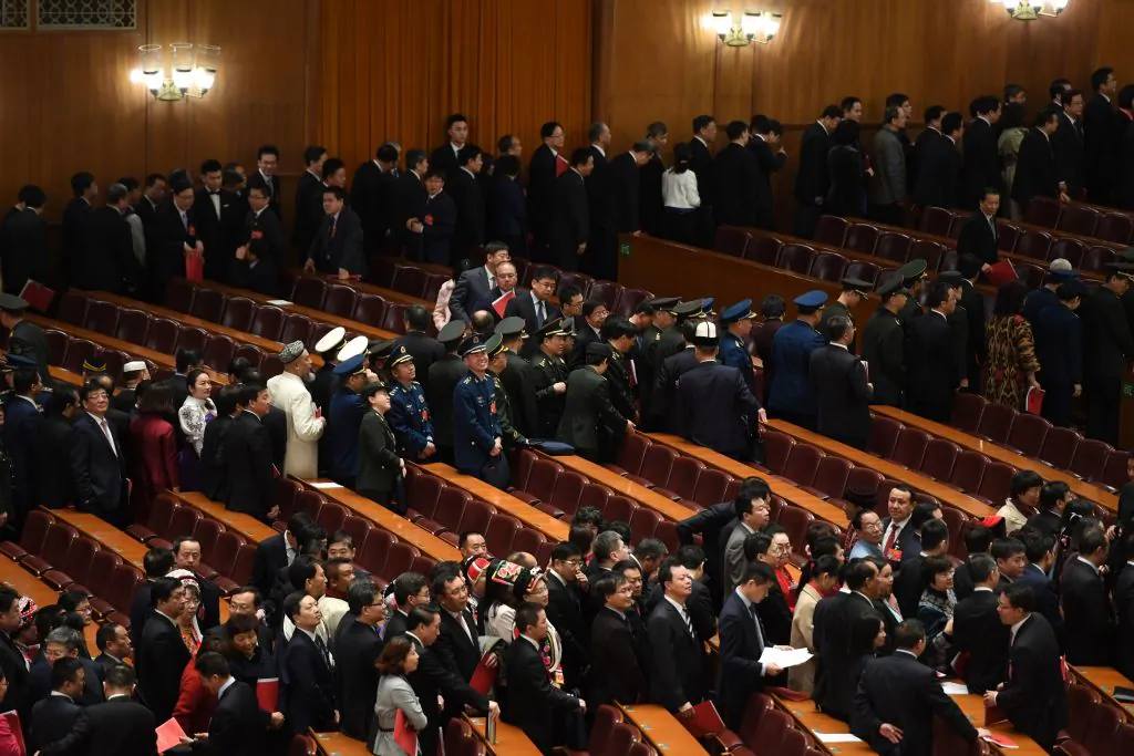 Delegates line up to leave after the closing session of the National People's Congress (NPC) in Beijing's Great Hall of the People when the rubber-stamp parliament approved a foreign investment law on March 15, 2019. (Greg Baker/AFP/Getty Images)