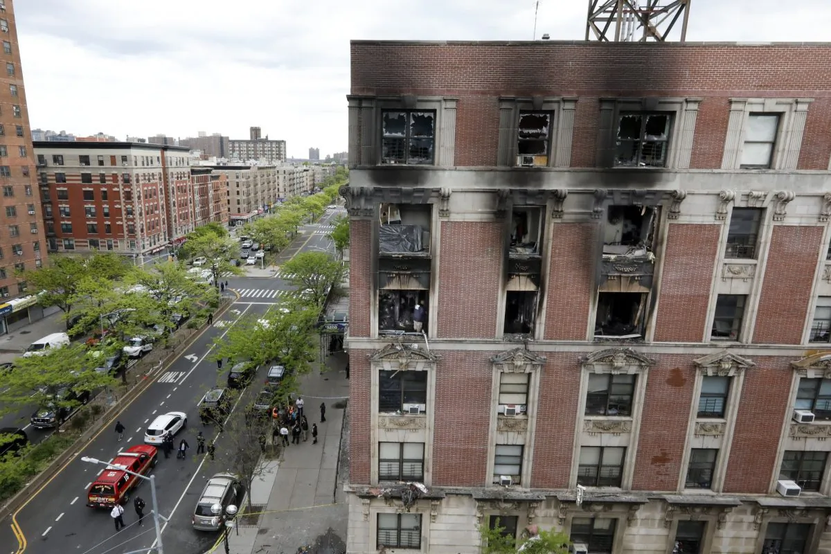 Fire marshals sift through a burned out apartment in New York's Harlem neighborhood on May 8, 2019. (Richard Drew/Photo via AP)