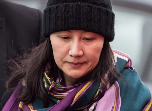 Huawei chief financial officer Meng Wanzhou, back right, is accompanied by a private security detail as she leaves her home to attend a court appearance in Vancouver on May 8, 2019. (The Canadian Press/Darryl Dyck)