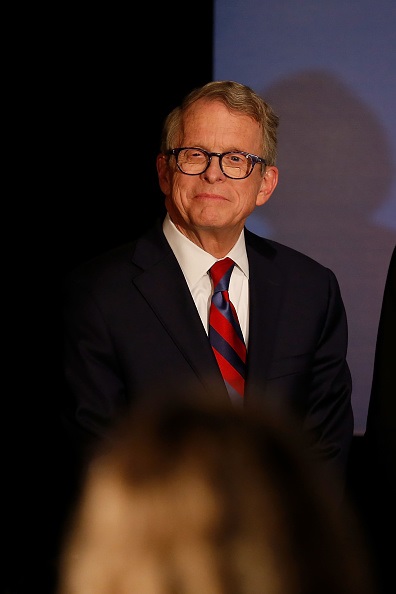 Republican Gubernatorial Candidate Ohio Attorney General Mike DeWine listens as Governor John Kasich gives a speech