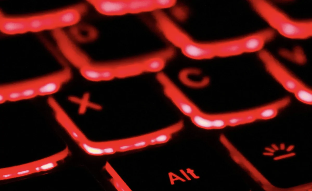 Close-up of keys on red backlit keyboard. (Unsplash)