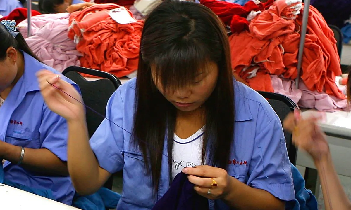 A woman sewing in a factory in China. (China Photos/Getty Images)