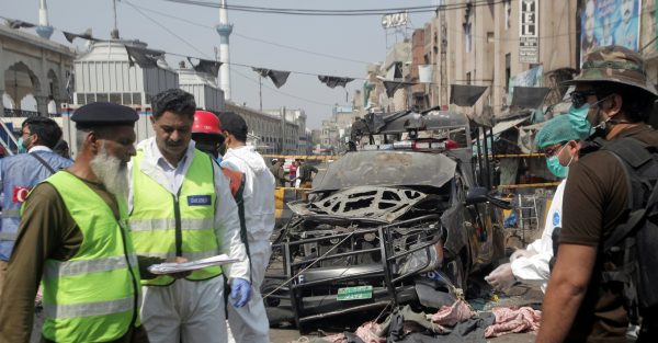Security officials and members of a bomb disposal team