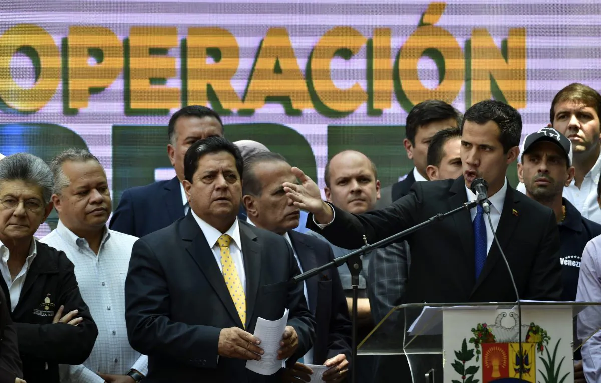 Venezuelan opposition leader Juan Guaido (R) speaks next to the vice-president of the Venezuelan National Assembly Edgar Zambrano (C) and its former president Henry Ramos Allup (L), in Caracas on March 27, 2019. (Yuri Cortez/AFP/Getty Images)