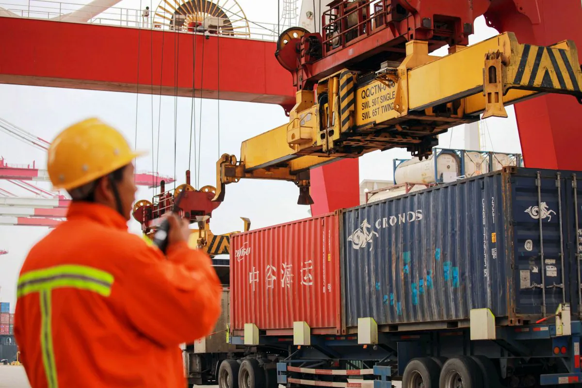 An employee watches over cranes as he talks on his interphone at a port in Qingdao, east China's Shandong Province on Nov. 8, 2018. (AFP/Getty Images)