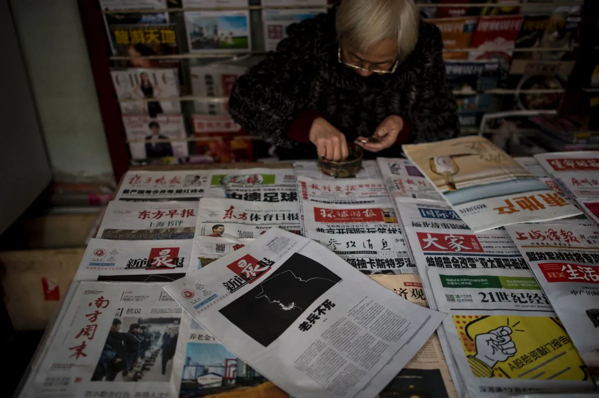 A seller shows Chinese newspapers at a news stand in Shanghai on November 27, 2016.
(JOHANNES EISELE/AFP/Getty Images)