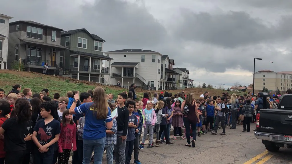 People wait outside near the STEM School during a shooting incident in Highlands Ranch, Colorado, U.S. on May 7, 2019. (SHREYA NALLAPATI/VIA REUTERS)