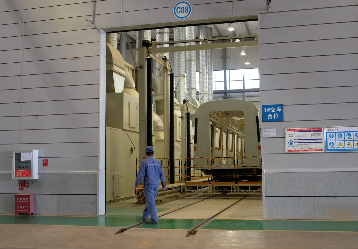 A CRRC worker walks past an unfinished metro train car in the company's Kunming factory, Yunnan Province, China on April 11, 2016. (Brenda Goh/Reuters)