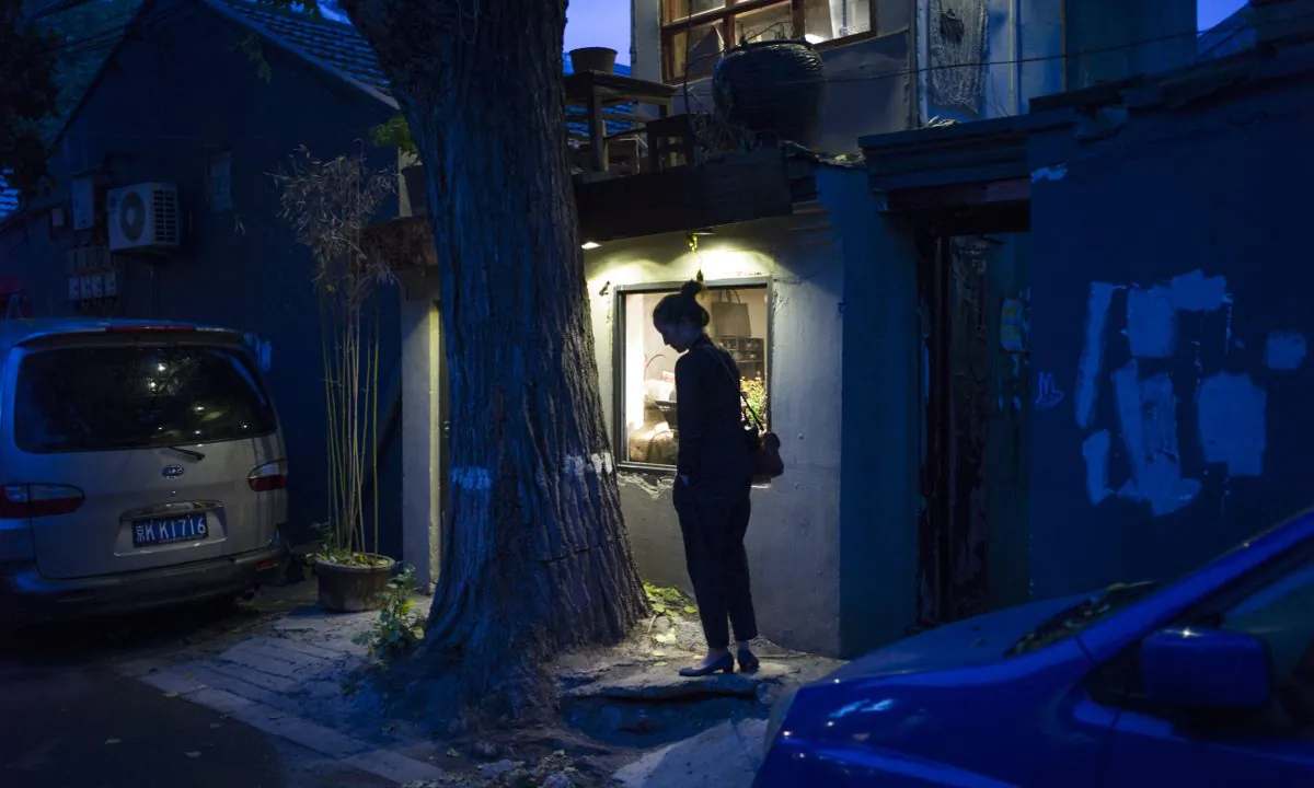 A woman in front of a house in China. (FRED DUFOUR/AFP/Getty Images)