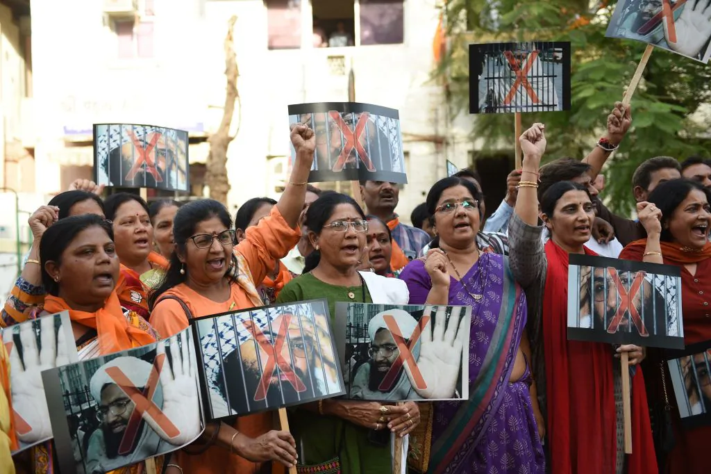Indians hold placards with a photograph of Pakistan-based terrorist Masood Azhar, in support of a recent decision by the United Nation to blacklist Azhar, in Ahmedabad on May 2, 2019. (Sam Panthaky/AFP/Getty Images)