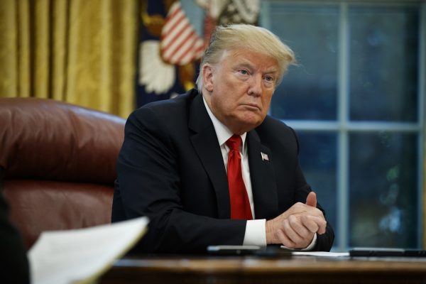 President Donald Trump listens