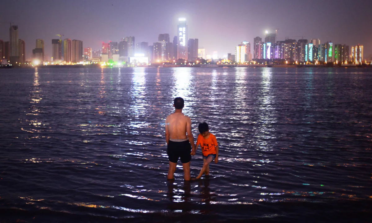 A man and his son standing in the Yangtze River in Wuhan. (Wang Zhao/AFP/Getty Images)