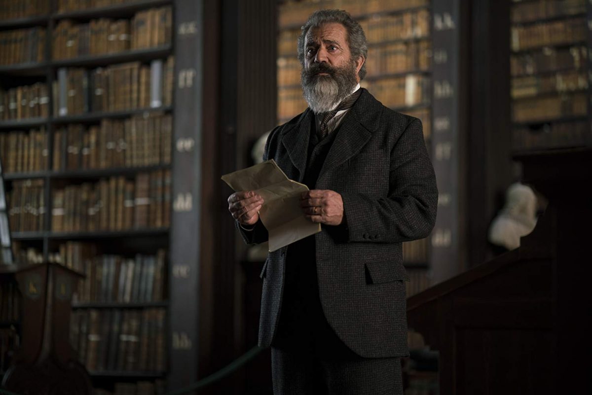 19th century man with letter in library