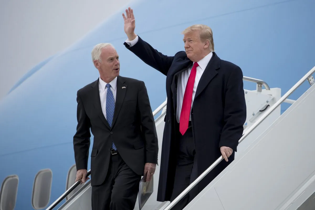 President Donald Trump, right, accompanied by Sen. Ron Johnson (R-Wis.) left, arrives at Green Bay Austin Straubel International Airport in Green Bay, Wis., on April 27, 2019. (AP Photo/Andrew Harnik, File)