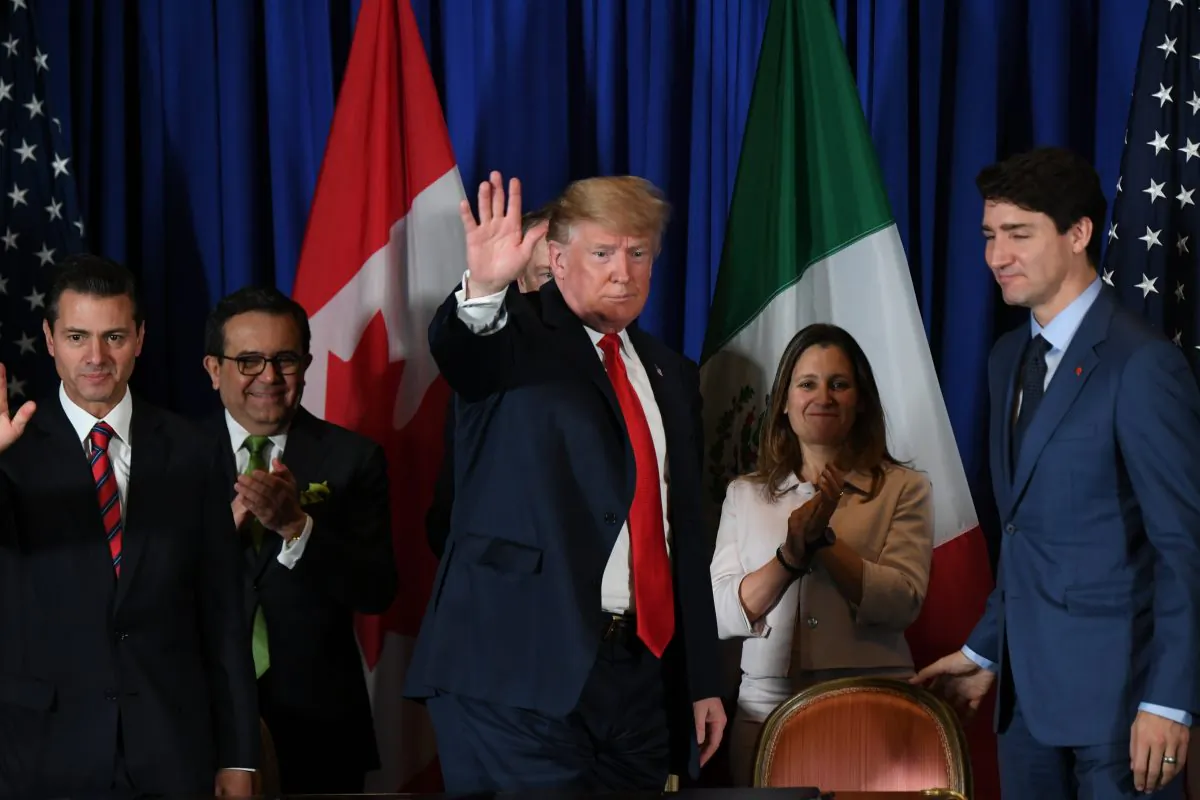 U.S. President Donald Trump (C) waves next to Mexican President Enrique Pena Nieto (L), Mexican Economy Minister Ildefonso Guajardo (2-L) Canadas Foreign Affairs Minister Chrystia Freeland (2-R) and Canadian Prime Minister Justin Trudeau, after signing a new free trade agreement in Buenos Aires, on Nov. 30, 2018. MARTIN BERNETTI/AFP/Getty Images
