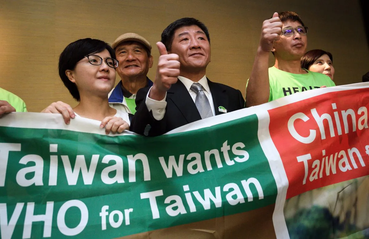 Taiwan's health Minister Chen Shih-chung (C) gives a thumb up as he poses with demonstrators after a press conference on the sideline of the World Health Organization annual Assembly on May 21, 2018 in Geneva. FABRICE COFFRINI/AFP/Getty Images)