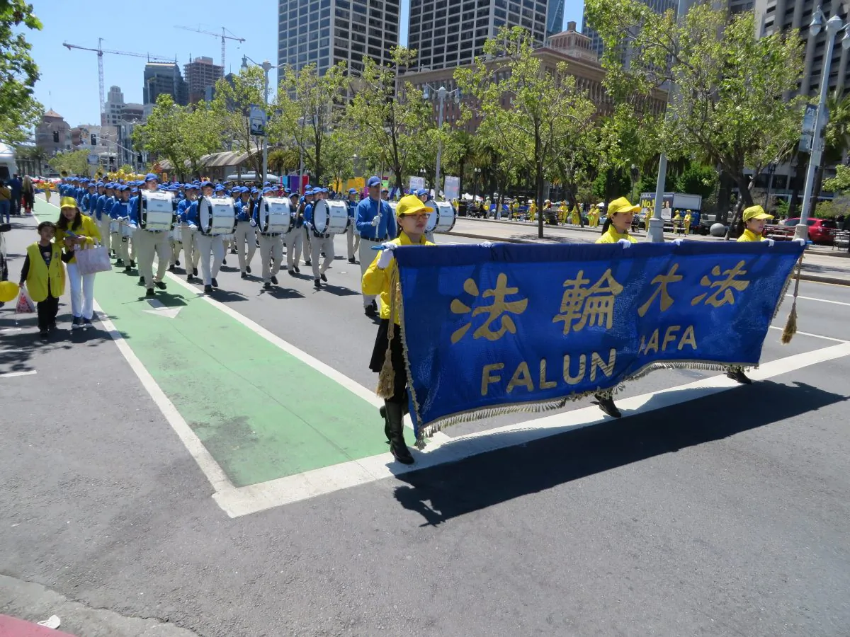 San Francisco Falun Dafa practitioners walk in a parade to celebrate World Falun Dafa Day on May 11, 2019. (Nathan Su/The Epoch Times)