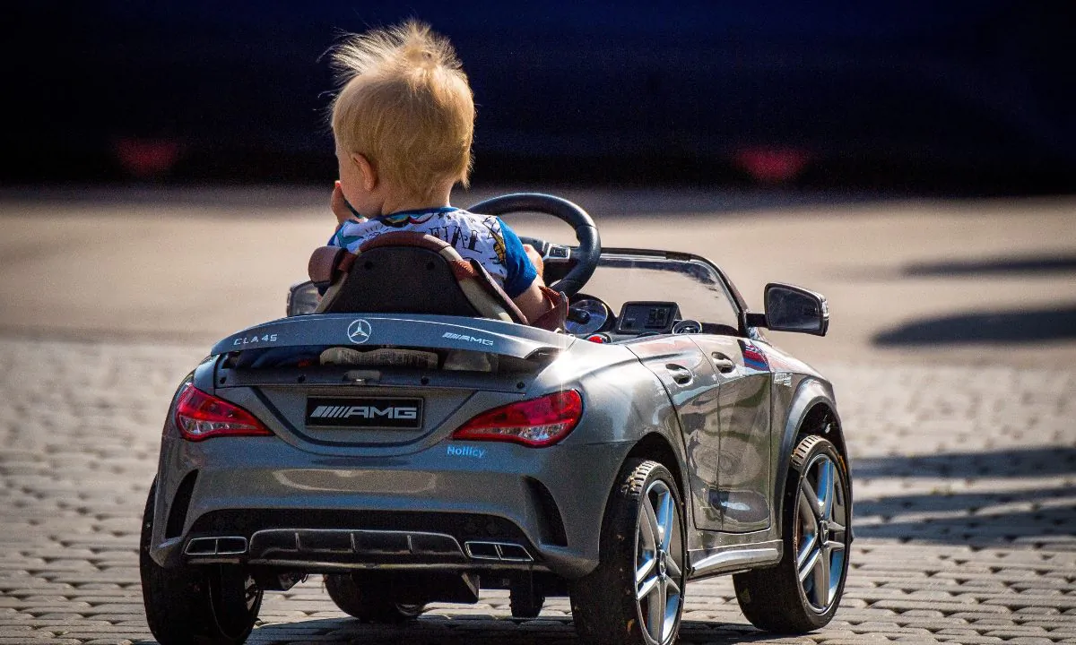 A boy in a toy car. (Mladen Antonov/AFP/Getty Images)