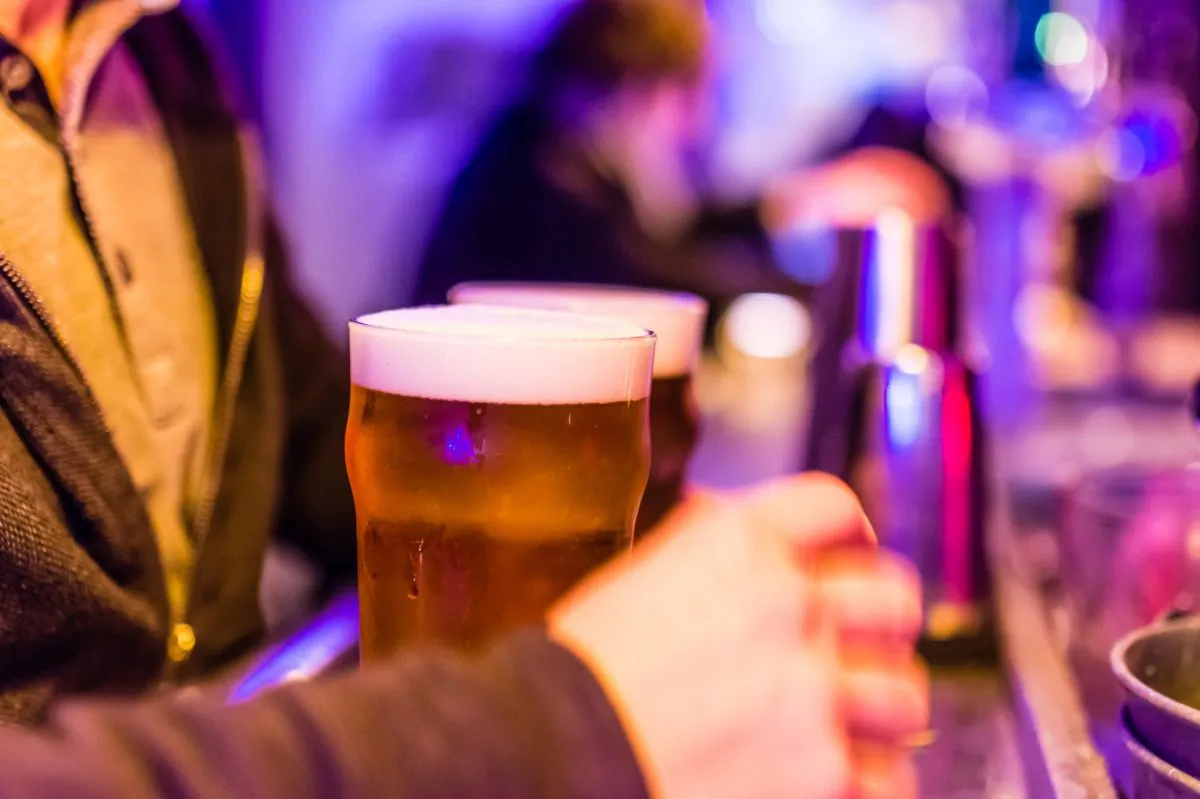 A man holding a beer in a stock photo. (Pixabay/CC0)