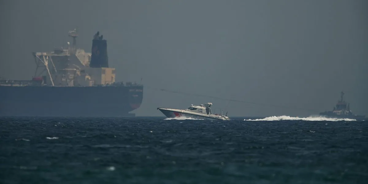 An Emirati coast guard vessel passes an oil tanker off the coast of Fujairah, United Arab Emirates,on May 13, 2019. (Jon Gambrell/AP Photo)