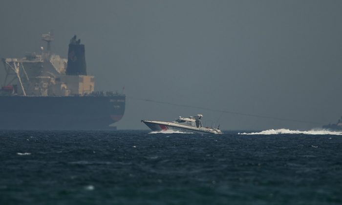 An Emirati coast guard vessel passes an oil tanker off the coast of Fujairah, United Arab Emirates,on May 13, 2019. (Jon Gambrell/AP Photo)