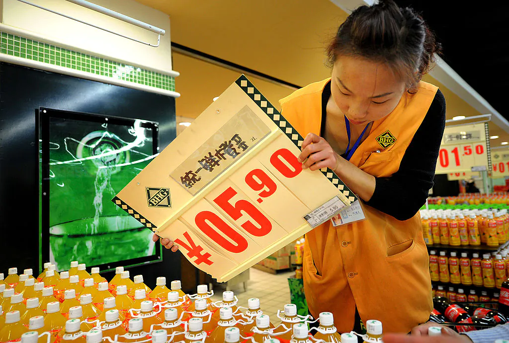 A Chinese worker changes a food price board at a supermarket in Hefei, east China's Anhui province on Nov. 17, 2010. (STR/AFP/Getty Images)
