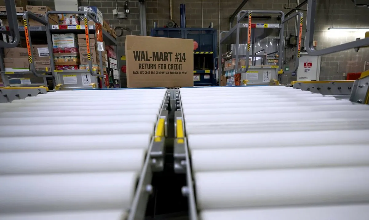 A box of merchandise is unloaded from a truck and sent along a conveyor belt at a Walmart Supercenter in Houston, on Nov. 9, 2018. (David J. Phillip/AP Photo)