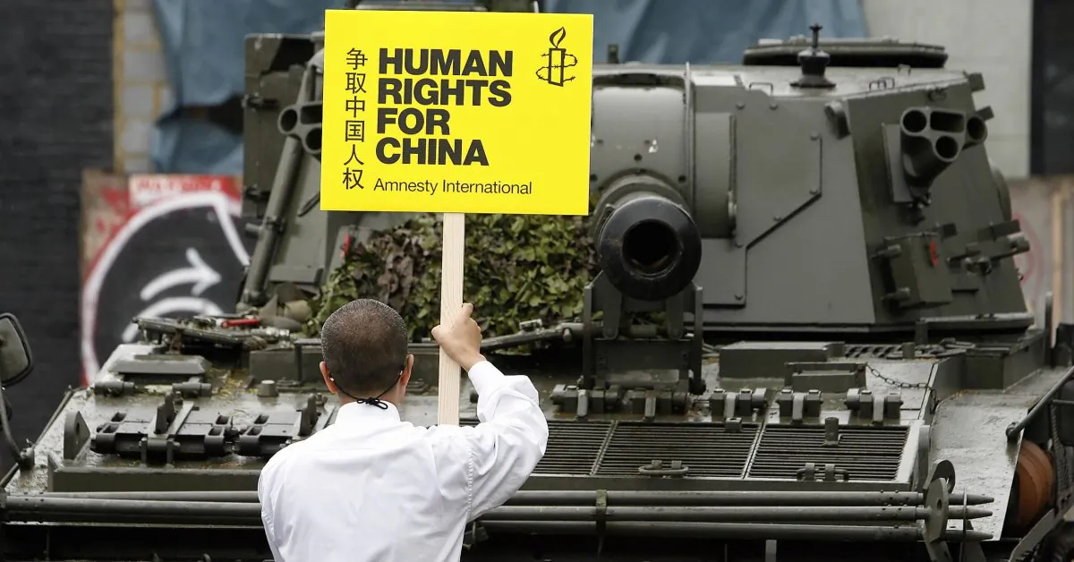 A man stands in front of a tank outside Amnesty International's headquarters in London on June 3, 2008 to recreate the "tank man" image of a lone demonstrator facing down tanks at Tiananmen Square. The anniversary of the 1989 crackdown against pro-democracy protesters in Beijing is on June 4. (Leon Neal/AFP/Getty Images)