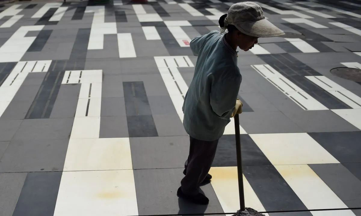 A woman cleaning (Greg Baker/AFP/Getty Images)