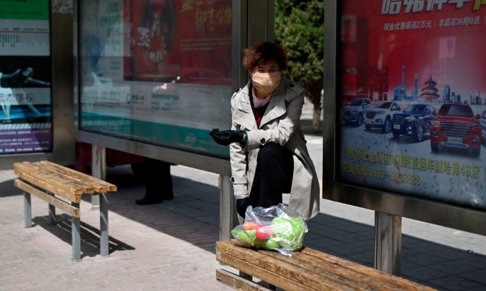 A woman waiting at a bus stop in China. (Wang Zhao/AFP/Getty Images)