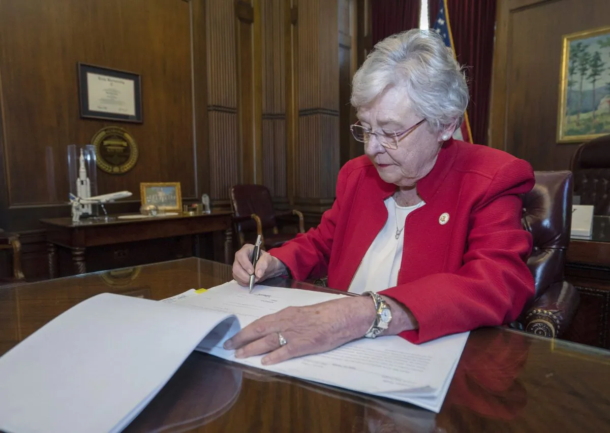 Alabama Gov. Kay Ivey signs a bill that virtually outlaws abortion in the state on May 15, 2019. (Hal Yeager/Alabama Governor's Office via AP)