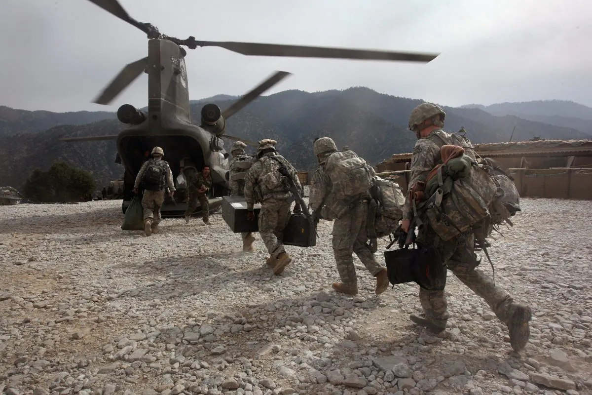 U.S. soldiers board an Army Chinook transport helicopter after it brought fresh soldiers and supplies to the Korengal Outpost in the Korengal Valley, Afghanistan, on Oct. 27, 2008.   John Moore/Getty Images