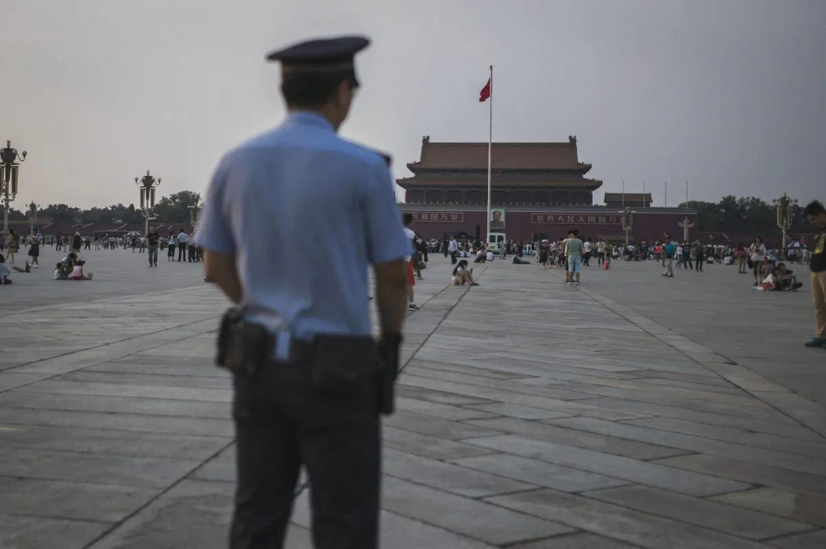 A Chinese policeman patrols as tourists gather in Tiananmen Square in Beijing on June 4, 2016, on the 27th anniversary of the June 4, 1989 crackdown on pro-democracy protests. (Fred Dufour/AFP/Getty Images)