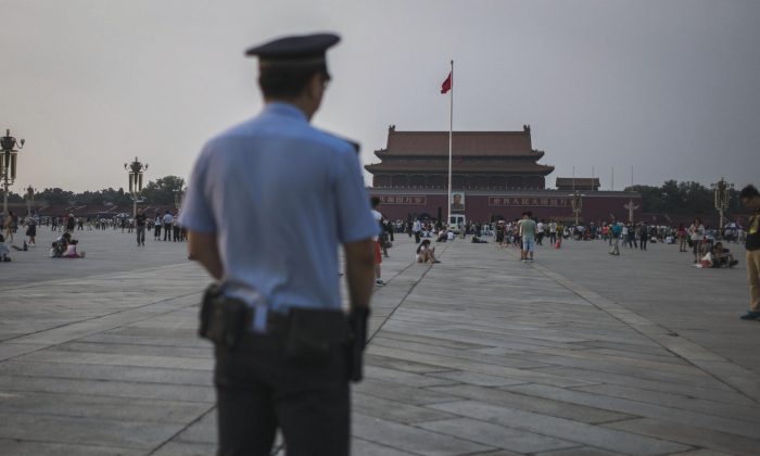 A Chinese policeman patrols as tourists gather in Tiananmen Square in Beijing on June 4, 2016, on the 27th anniversary of the June 4, 1989 crackdown on pro-democracy protests. (Fred Dufour/AFP/Getty Images)