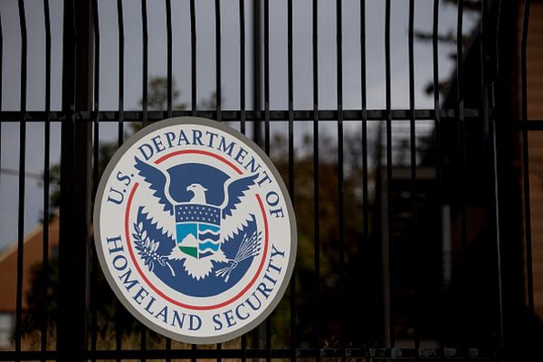 The U.S. Department of Homeland Security (DHS) seal hangs on a fence