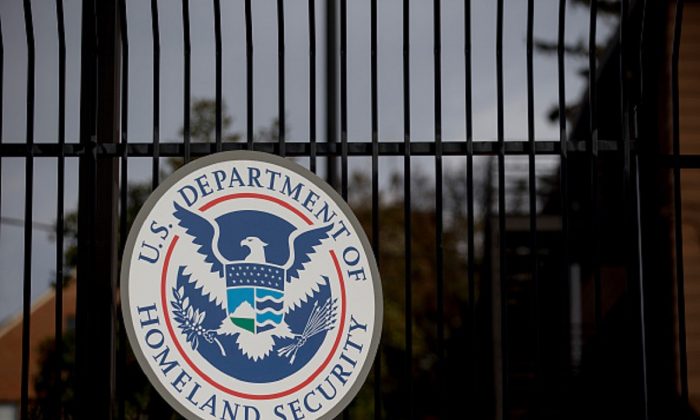 The U.S. Department of Homeland Security (DHS) seal hangs on a fence at the agency's headquarters in Washington, on Dec. 11, 2014. (Andrew Harrer/Bloomberg via Getty Images)