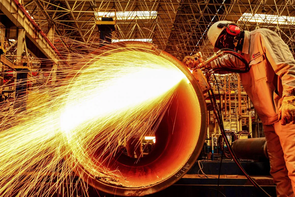 A worker cuts an oil pipe at a factory in Qingdao in China’s eastern Shandong Province on Feb. 28, 2019. China's manufacturing activity shrunk for a third straight month in February, sinking to its worst performance in three years as the economy slows and the U.S. trade war bites, official data showed on Feb. 28. (STR/AFP/Getty Images)
