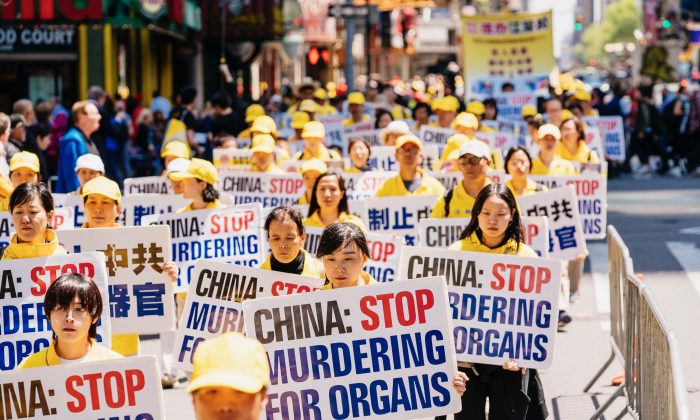 Falun Dafa practitioners raise awareness about forced organ harvesting atrocities in China, as they march through Manhattan celebrating World Falun Dafa Day, on May 16, 2019. (Edward Dye/The Epoch Times)