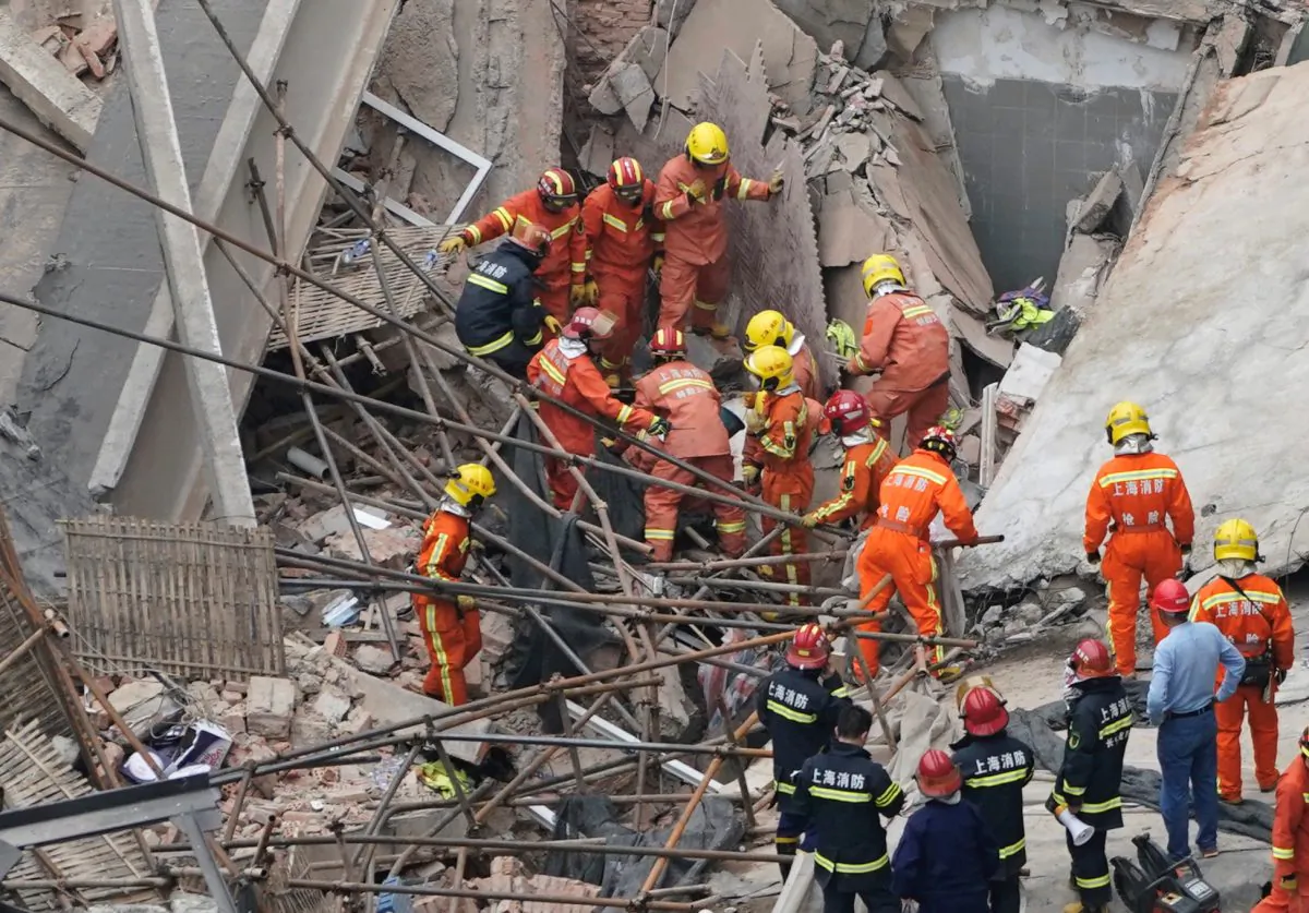 Firefighters work at the site where a building collapsed, in Shanghai, China on May 16, 2019. (Aly Song/Reuters)