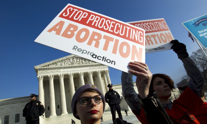 Abortion rights activists protest outside of the U.S. Supreme Court, during the March for Life in Washington. (Jose Luis Magana/AP)